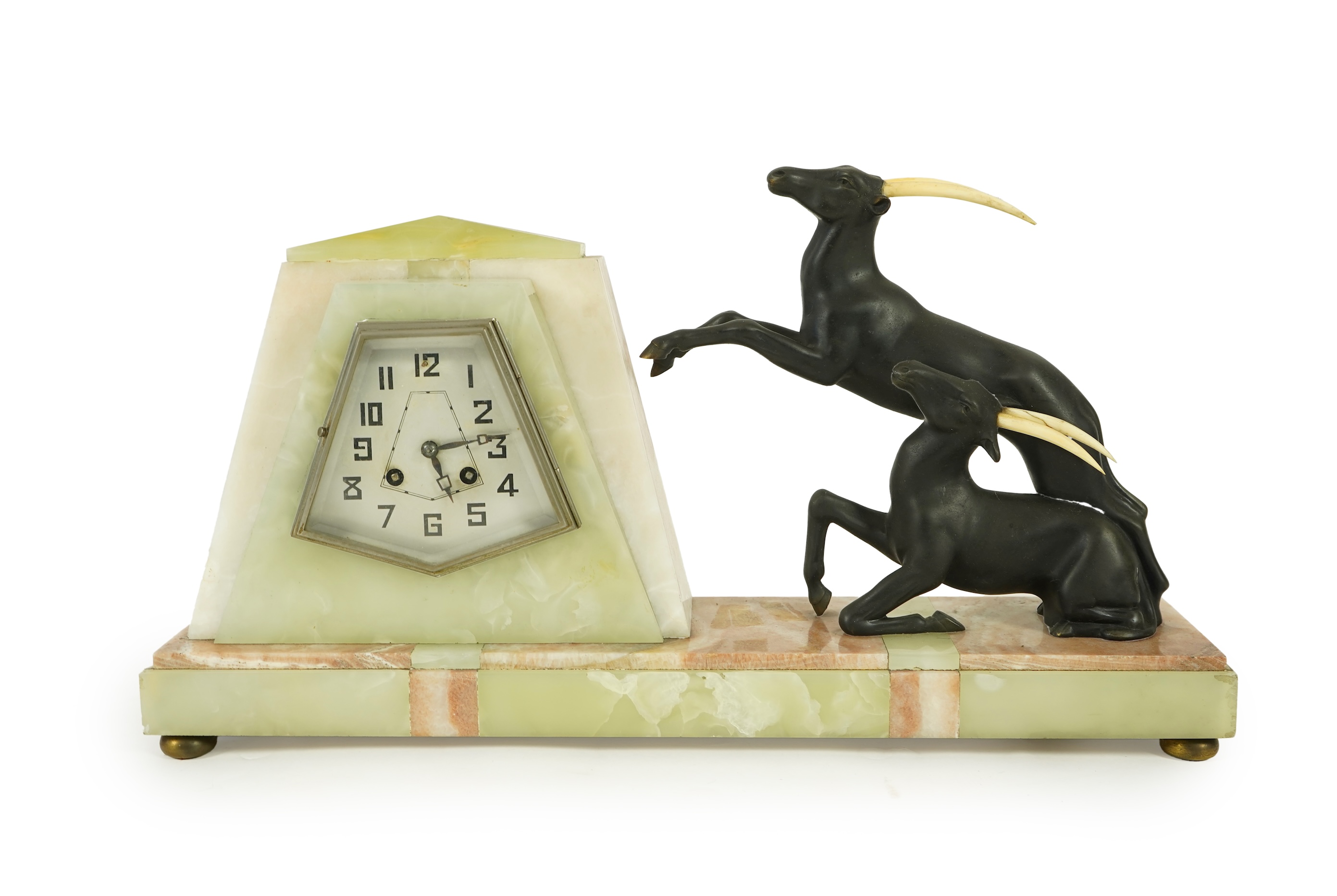 Attributed to Uriano (Ugo Cipriani, Italian, 1897-1960), a French green and cream onyx pyramid shaped clock
